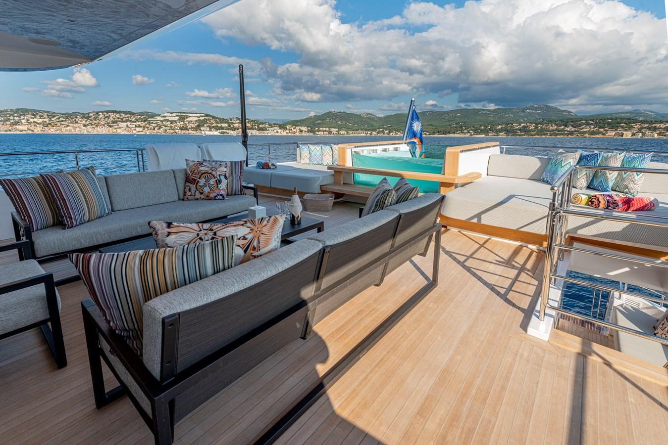 a deck with a view of the ocean and a beach aboard M55 Yacht for Sale
