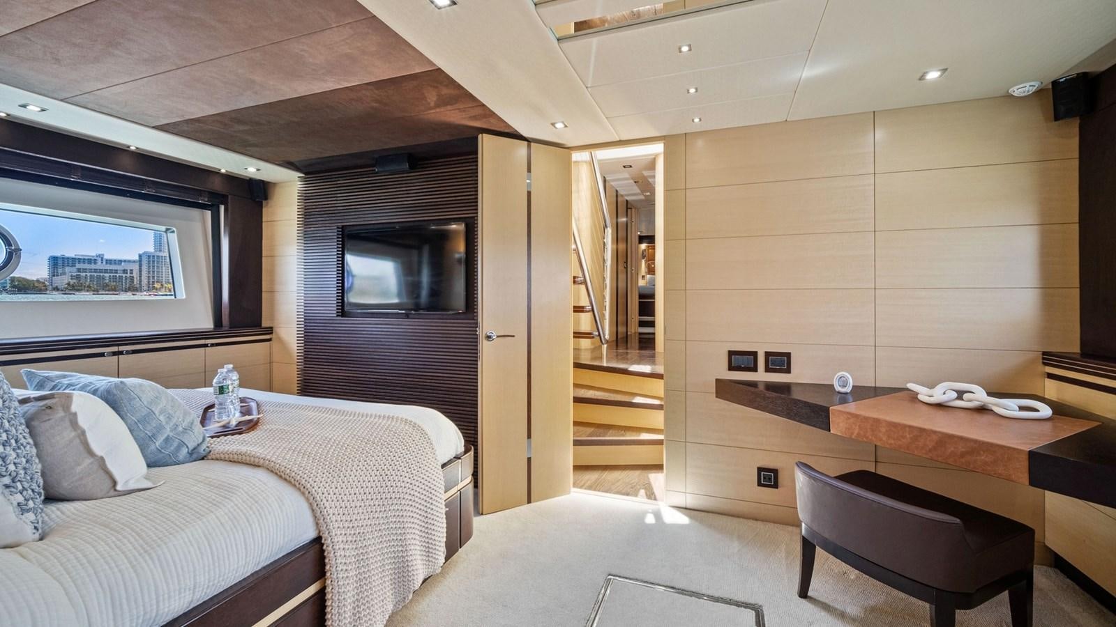 a bedroom with a bed and a desk aboard WOODEVER Yacht for Sale