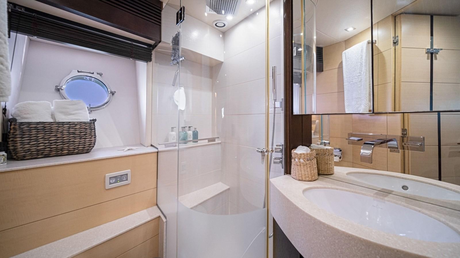 a bathroom with a tub sink and mirror aboard WOODEVER Yacht for Sale
