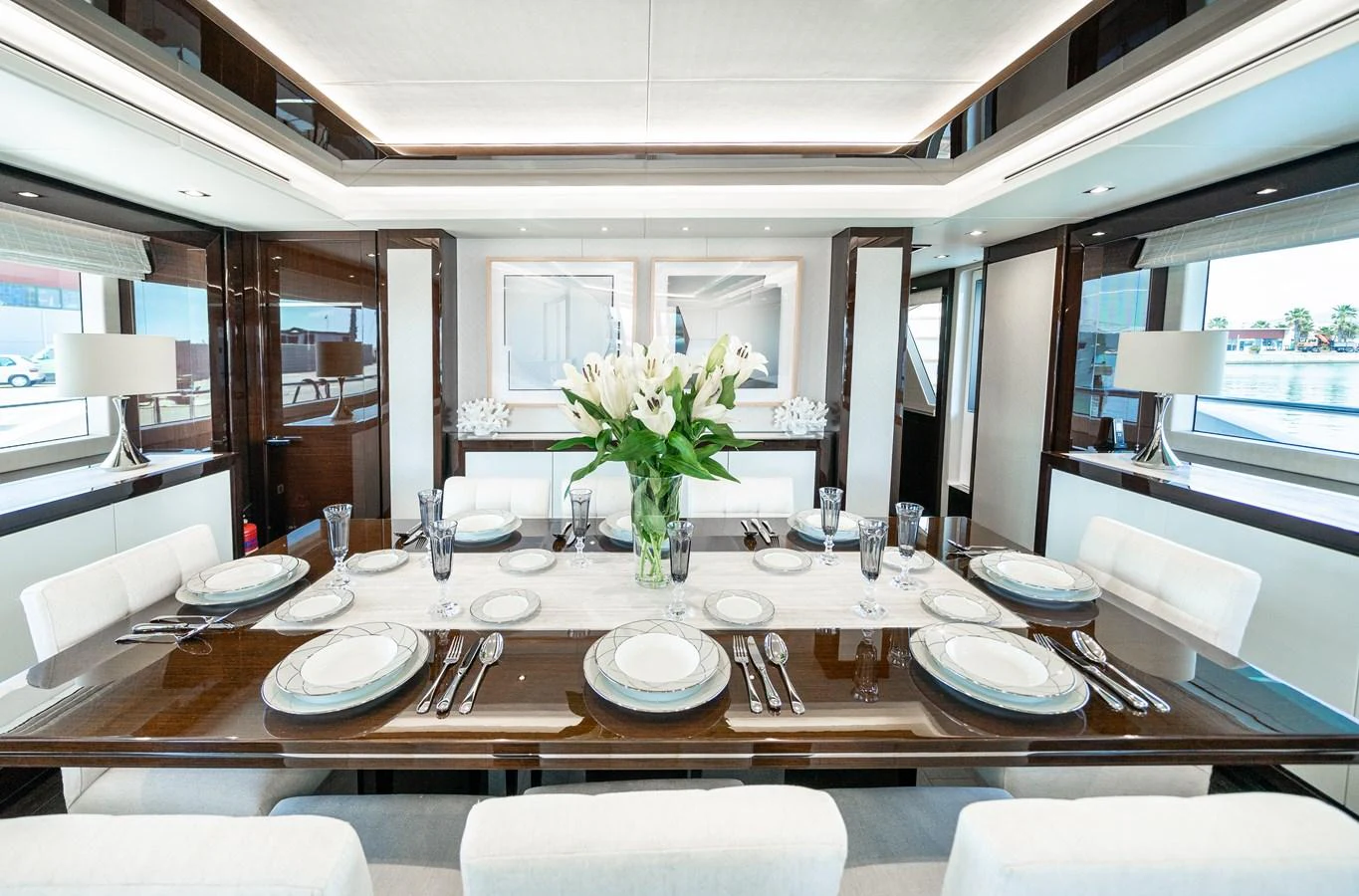 a dining table set with plates and flowers aboard SUNSEEKER 116 -  QART HADASHT Yacht for Sale