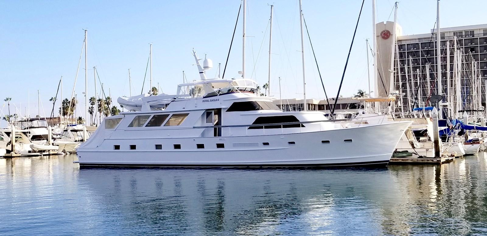 a white yacht in a harbor aboard ROYAL EAGLE II Yacht for Sale