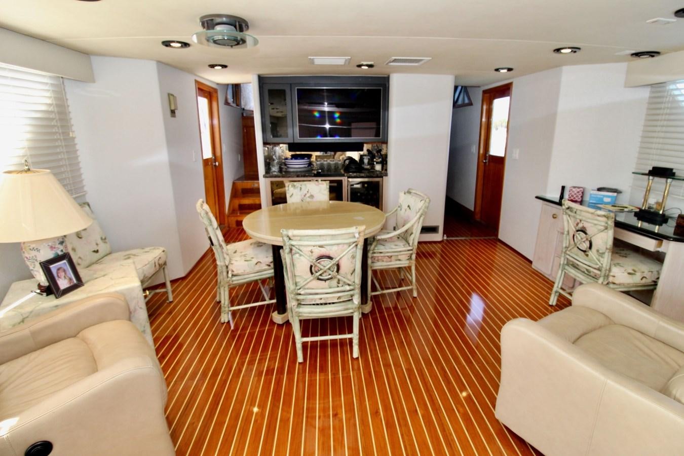 a living room with a table and chairs aboard ROYAL EAGLE II Yacht for Sale