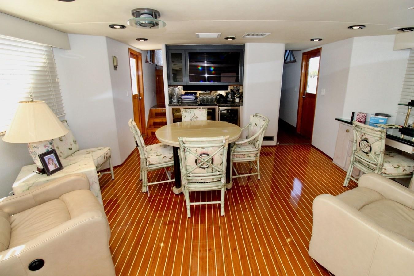 a living room with a table and chairs aboard ROYAL EAGLE II Yacht for Sale