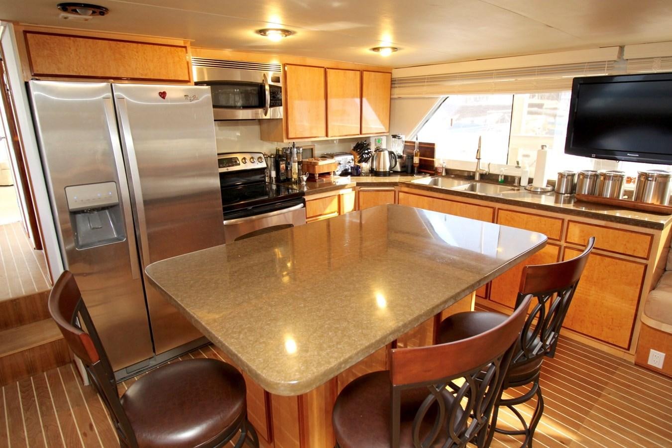 a kitchen with a stainless steel island aboard ROYAL EAGLE II Yacht for Sale