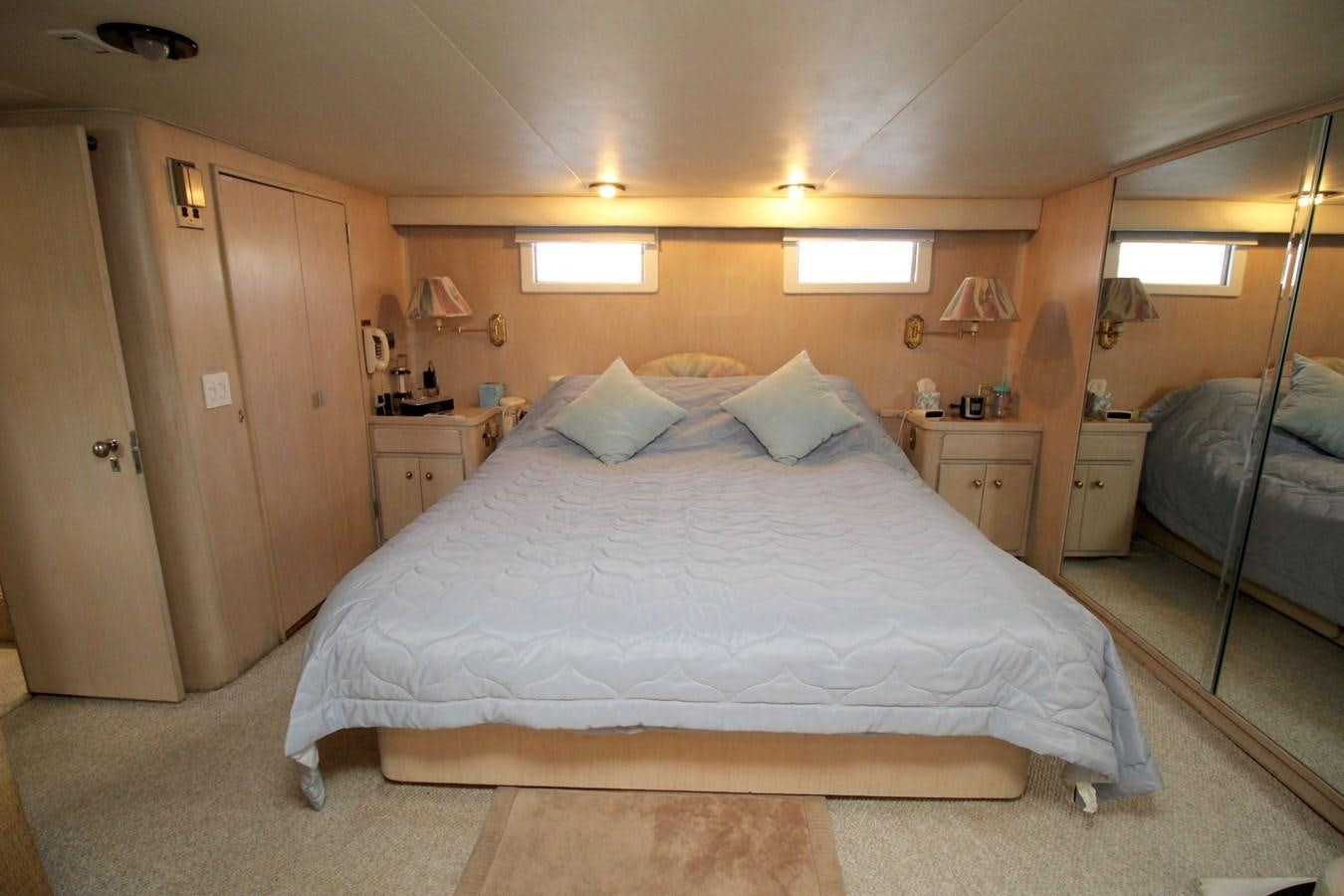 a bedroom with a bed and a desk aboard ROYAL EAGLE II Yacht for Sale