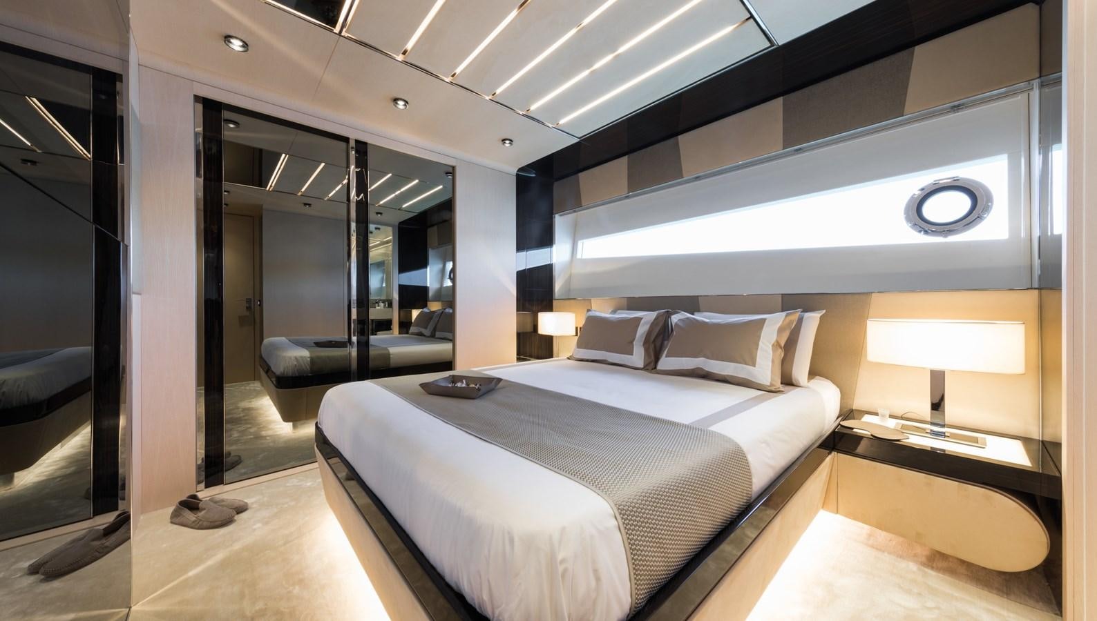 a room with a bed and a desk aboard YORAL Yacht for Sale