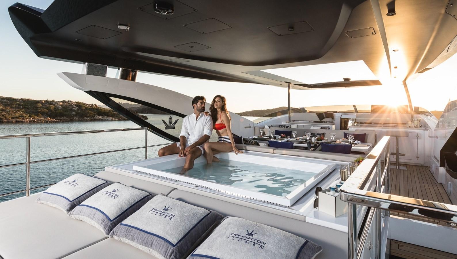 a man and woman sitting on a boat on the water aboard YORAL Yacht for Sale