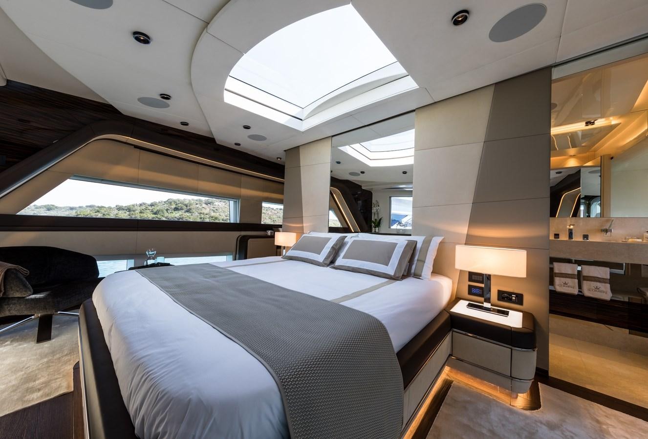 a room with a bed and a desk aboard YORAL Yacht for Sale