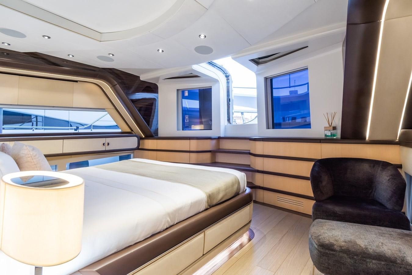 a room with a bed and a chair aboard YORAL Yacht for Sale
