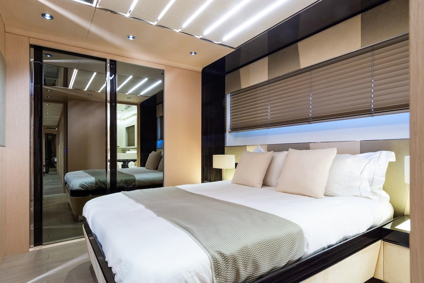 a room with a bed and a chair aboard YORAL Yacht for Sale