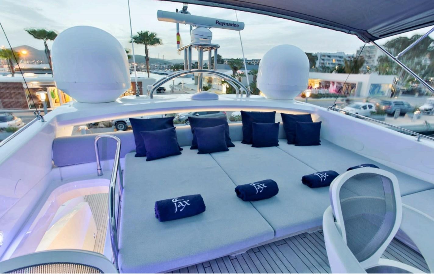 a large white table with blue chairs on it aboard JAX OF IBIZA Yacht for Sale