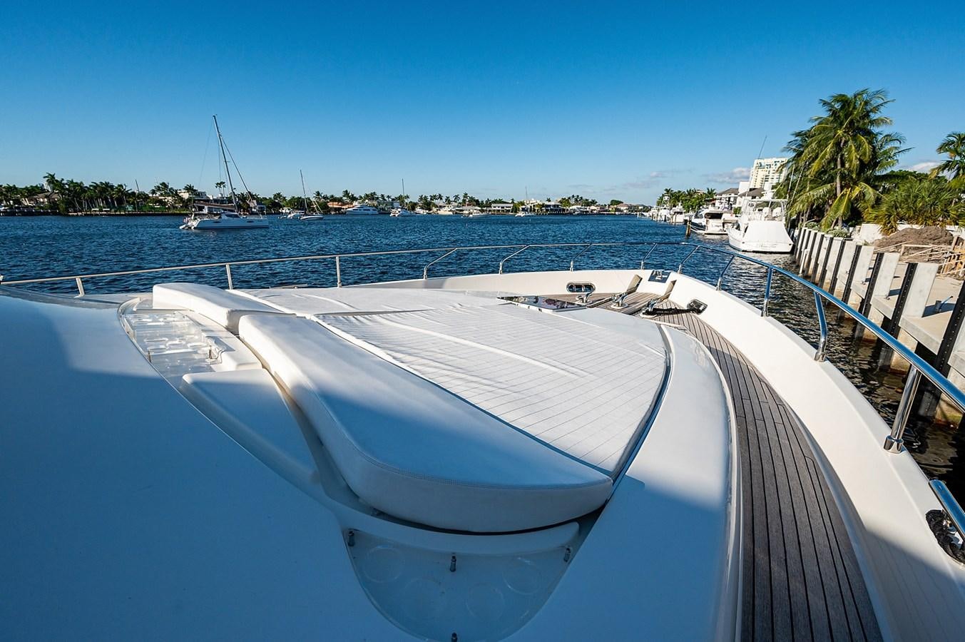 a pool with a deck and boats in the background aboard FERRETTI Yacht for Sale