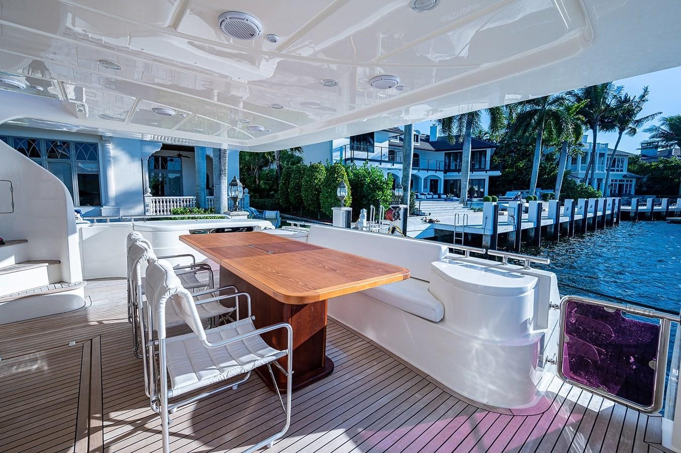 a pool with a table and chairs aboard FERRETTI Yacht for Sale