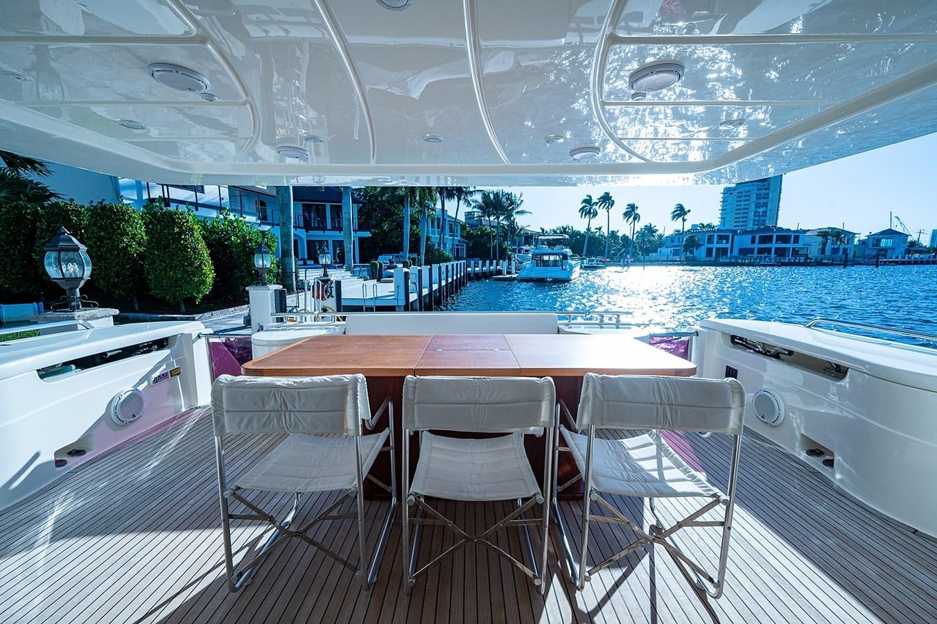 a table and chairs on a deck aboard FERRETTI Yacht for Sale