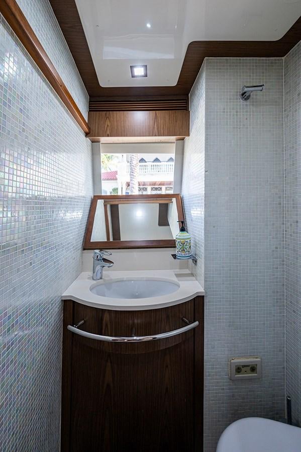 a bathroom with a sink and a mirror aboard FERRETTI Yacht for Sale