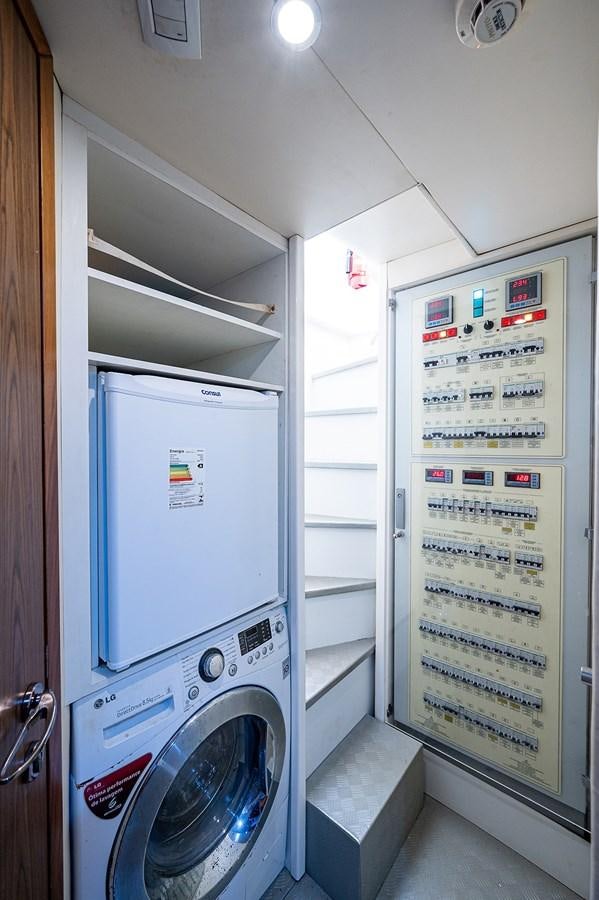 a washing machine in a room aboard FERRETTI Yacht for Sale