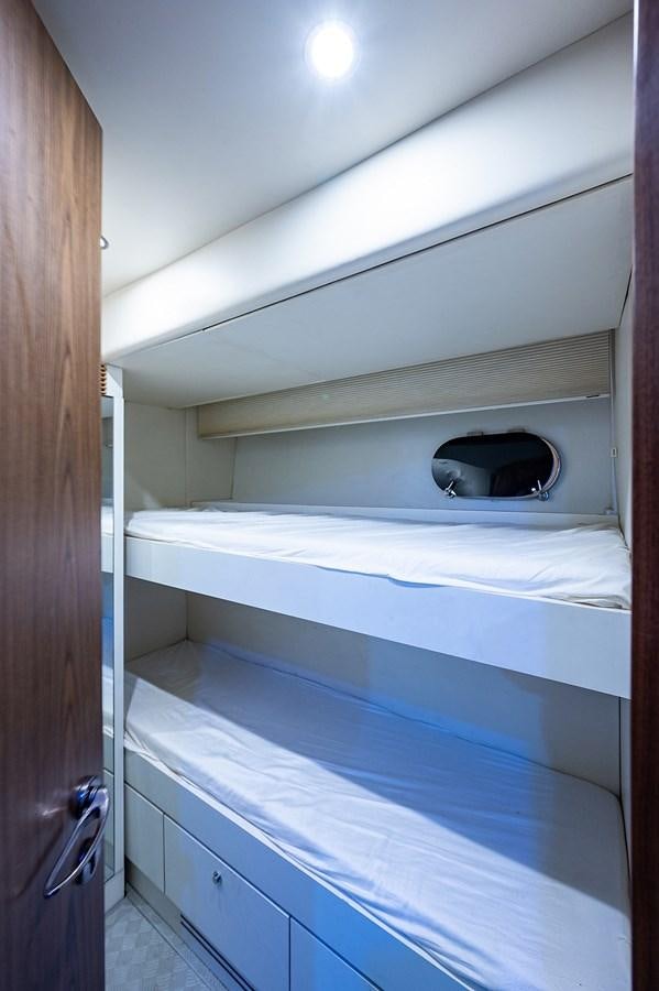 a small room with bunk beds aboard FERRETTI Yacht for Sale