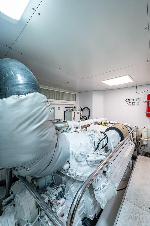 a person in a room with a large white machine aboard FERRETTI Yacht for Sale