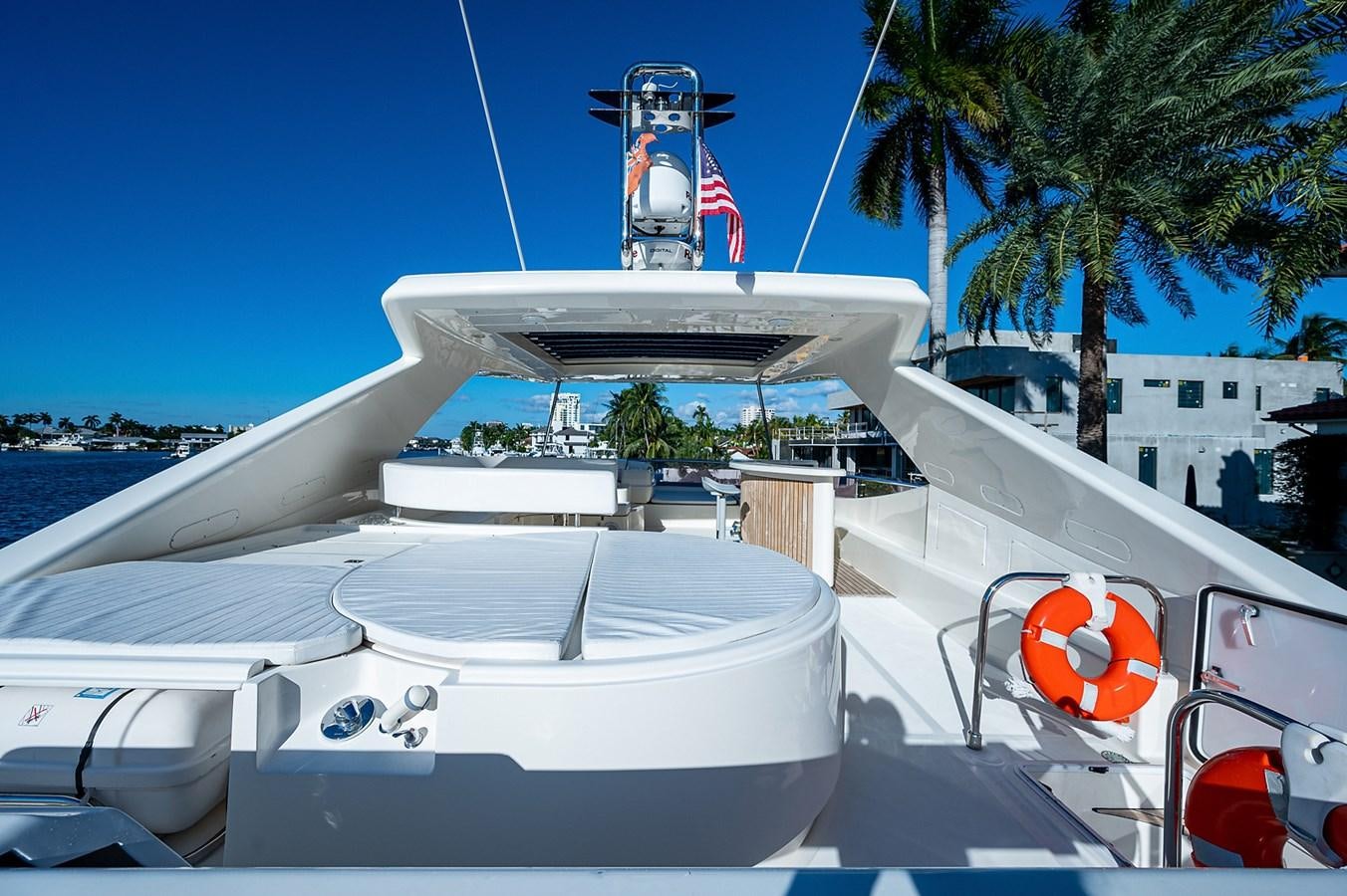 a white boat with a flag on it aboard FERRETTI Yacht for Sale