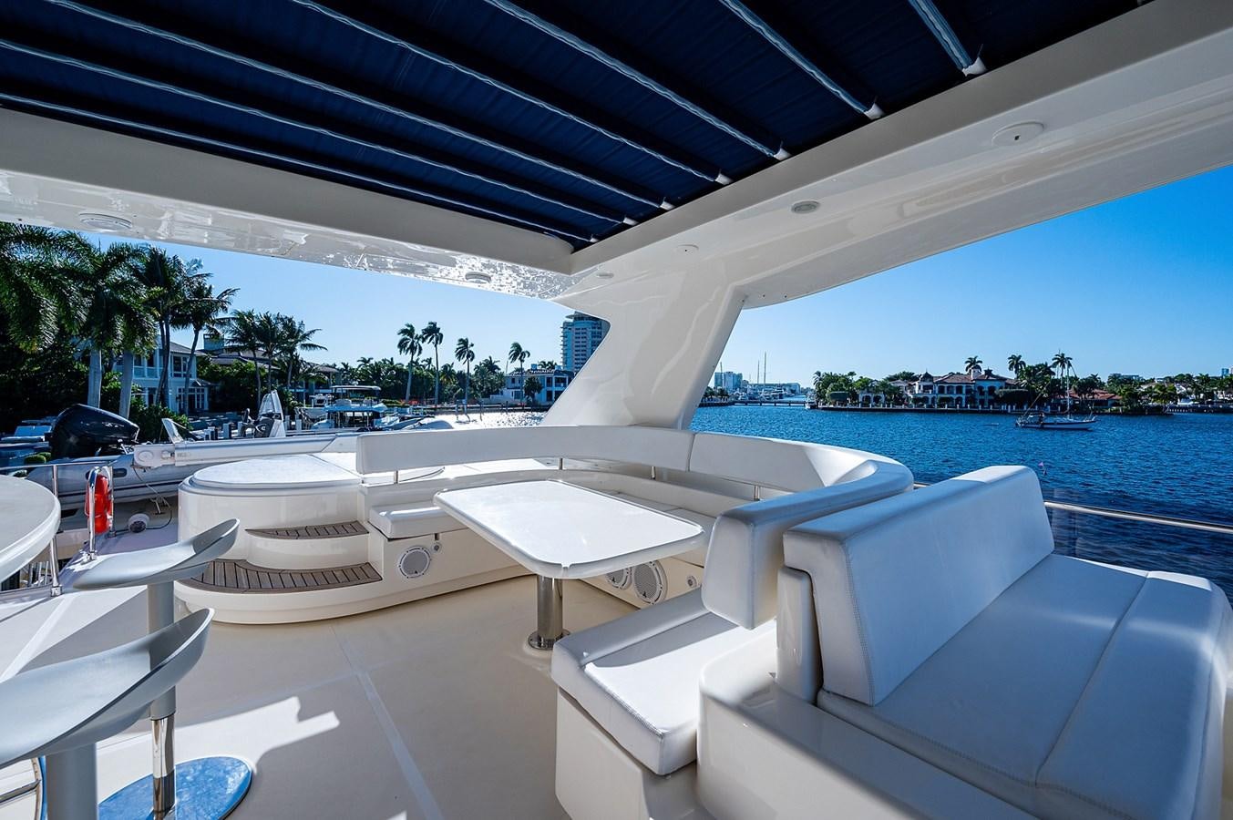 a lounge area with lounge chairs and a body of water in the background aboard FERRETTI Yacht for Sale