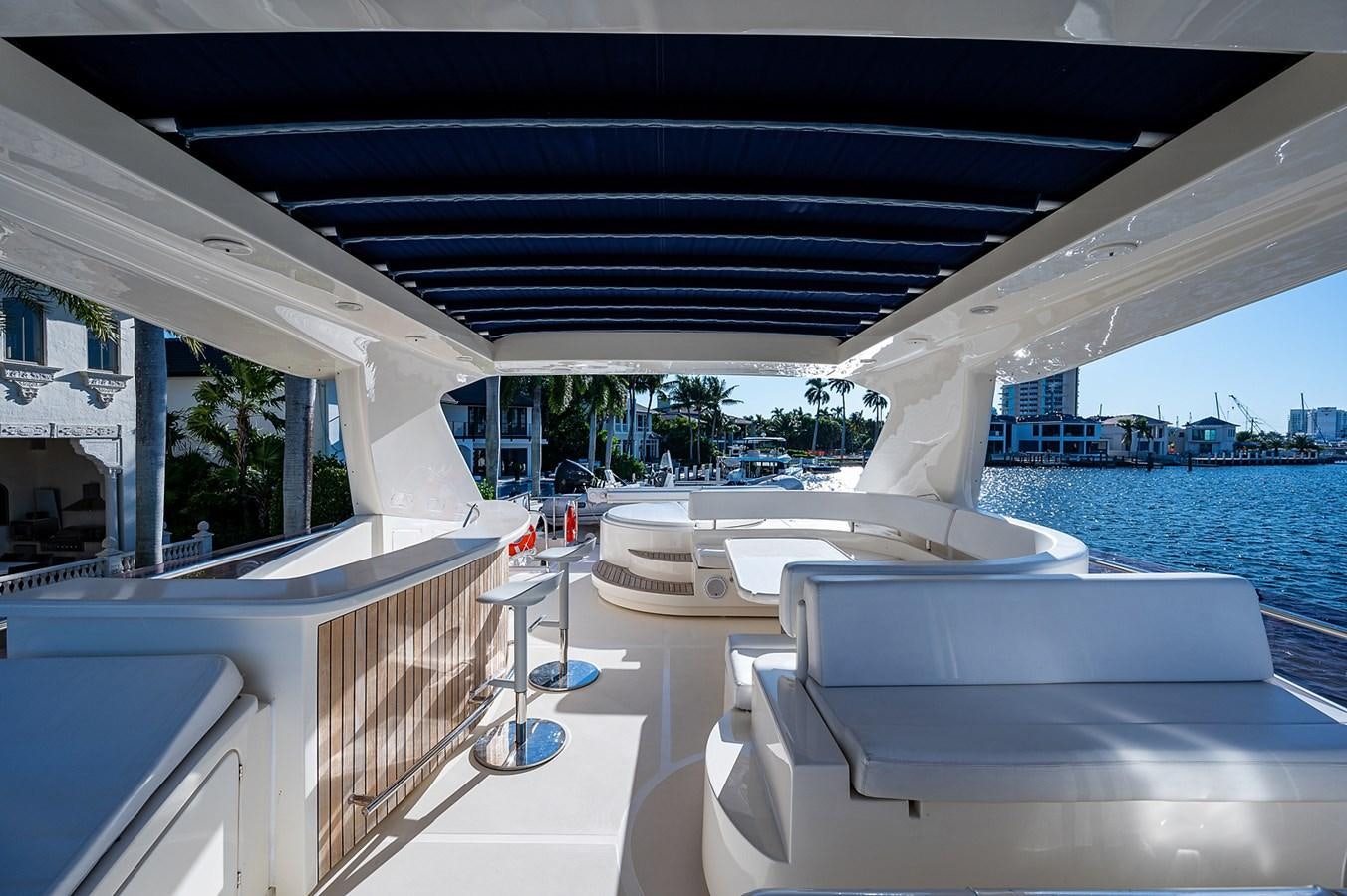 a room with a pool and a deck with a view of the water aboard FERRETTI Yacht for Sale