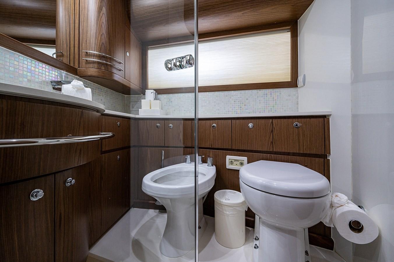 a bathroom with a toilet and a sink aboard FERRETTI Yacht for Sale