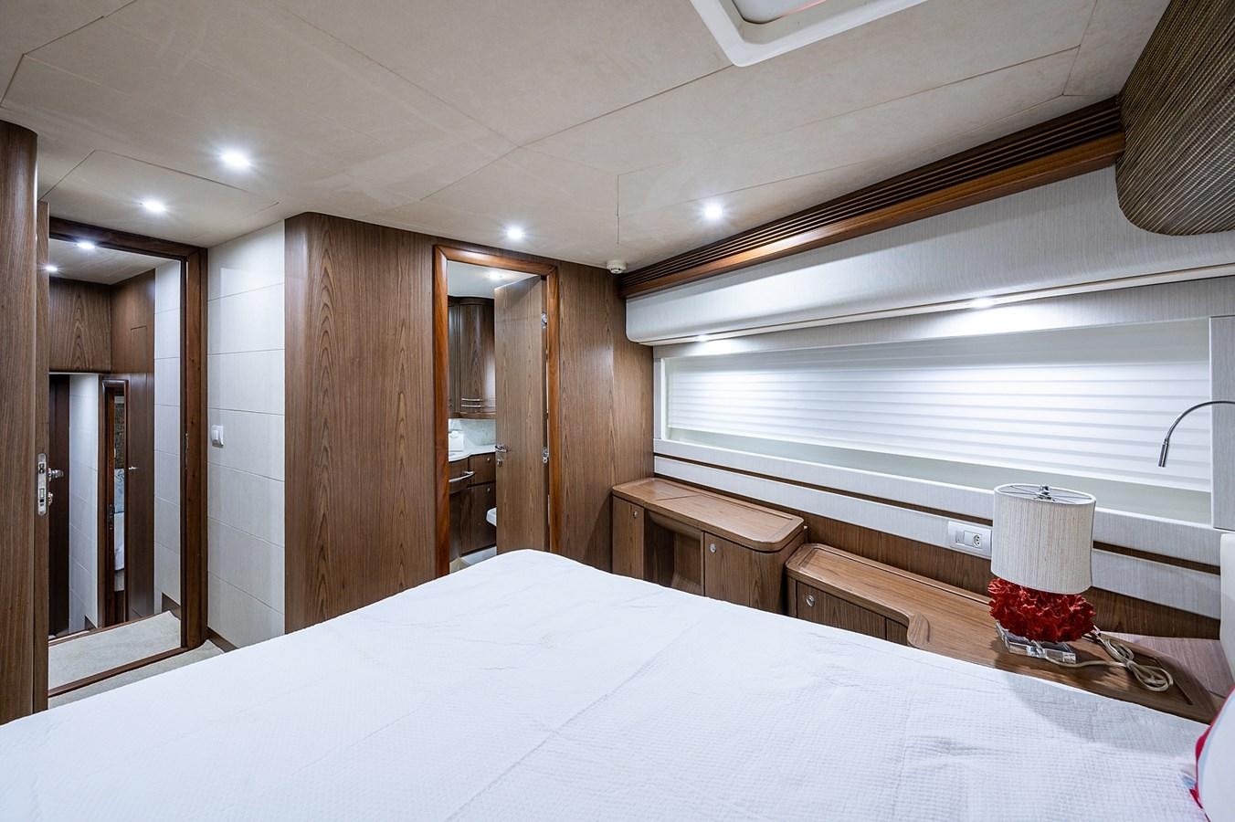 a room with a bed and a lamp aboard FERRETTI Yacht for Sale