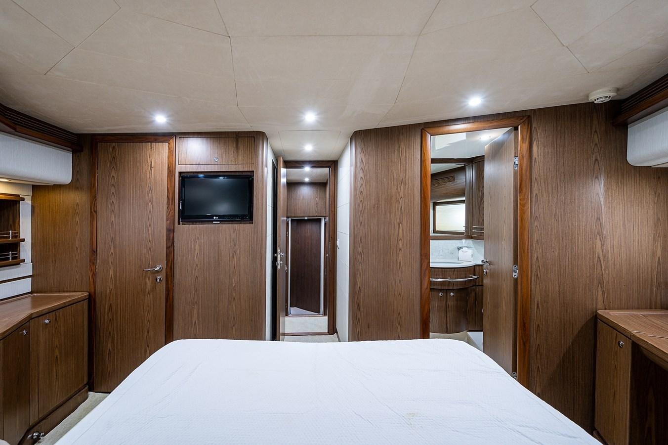 a bedroom with a bed and a television aboard FERRETTI Yacht for Sale