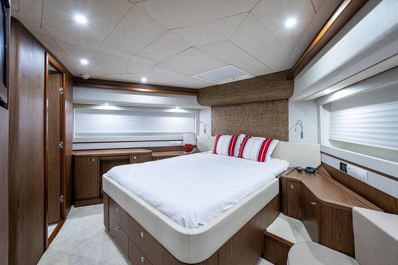 a room with a bed and a dresser aboard FERRETTI Yacht for Sale