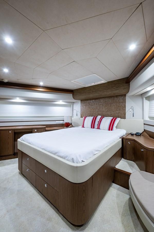 a bedroom with a bed and a window aboard FERRETTI Yacht for Sale