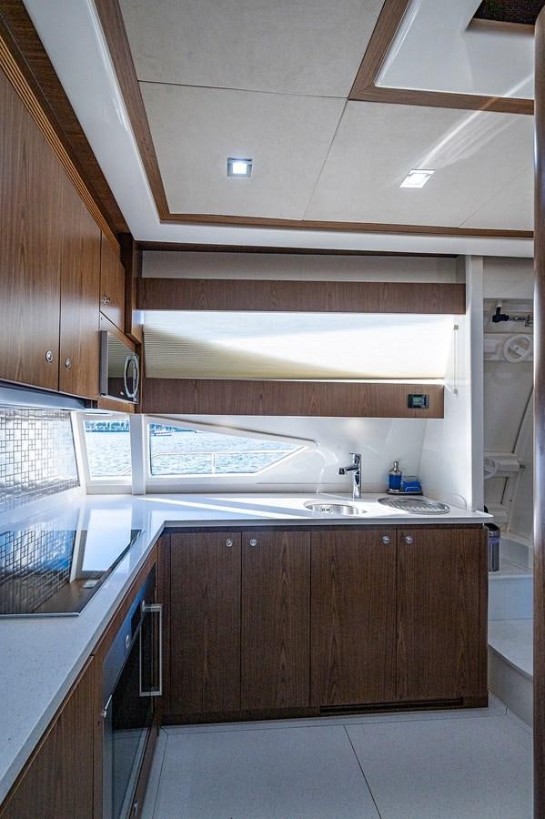 a kitchen with a microwave oven and a sink aboard FERRETTI Yacht for Sale