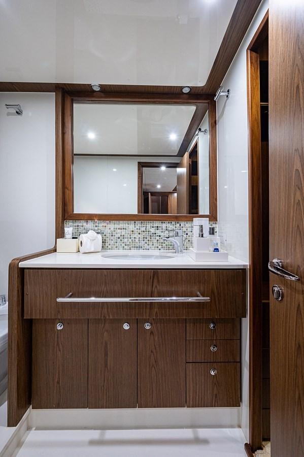 a bathroom with a sink and a mirror aboard FERRETTI Yacht for Sale