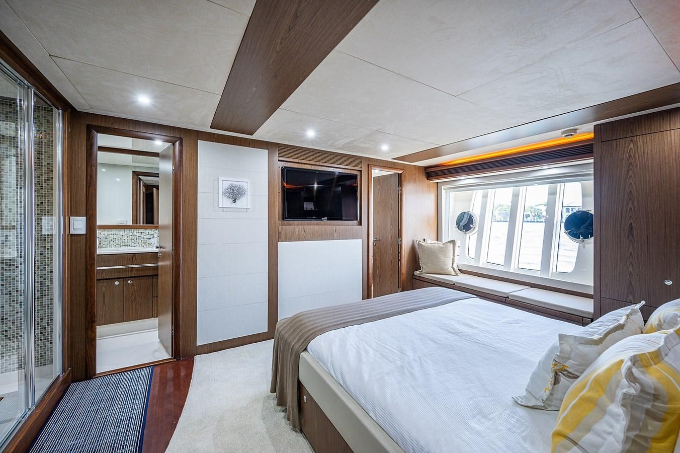 a bedroom with a bed and a window aboard FERRETTI Yacht for Sale