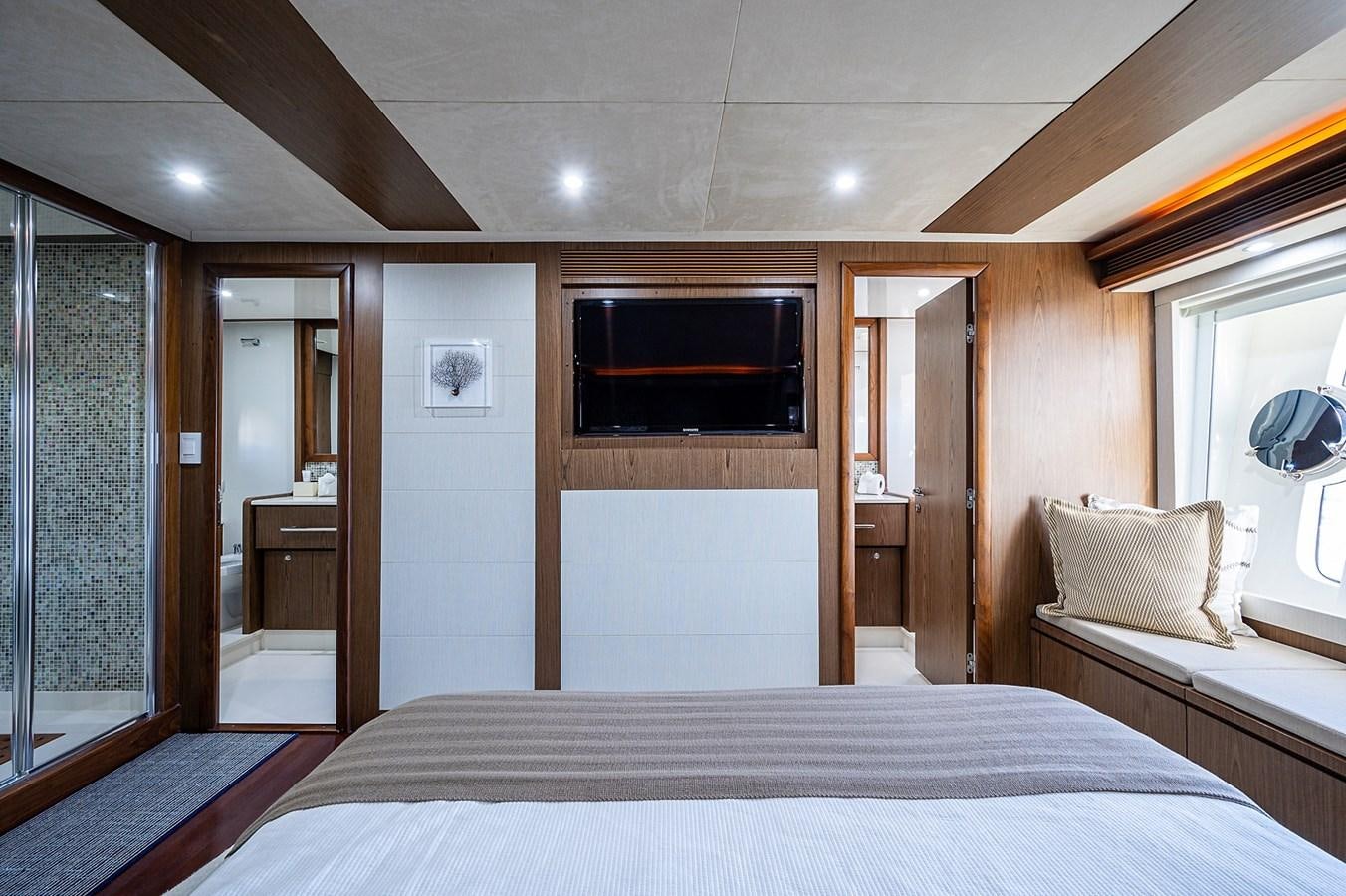 a bedroom with a bed and a television aboard FERRETTI Yacht for Sale