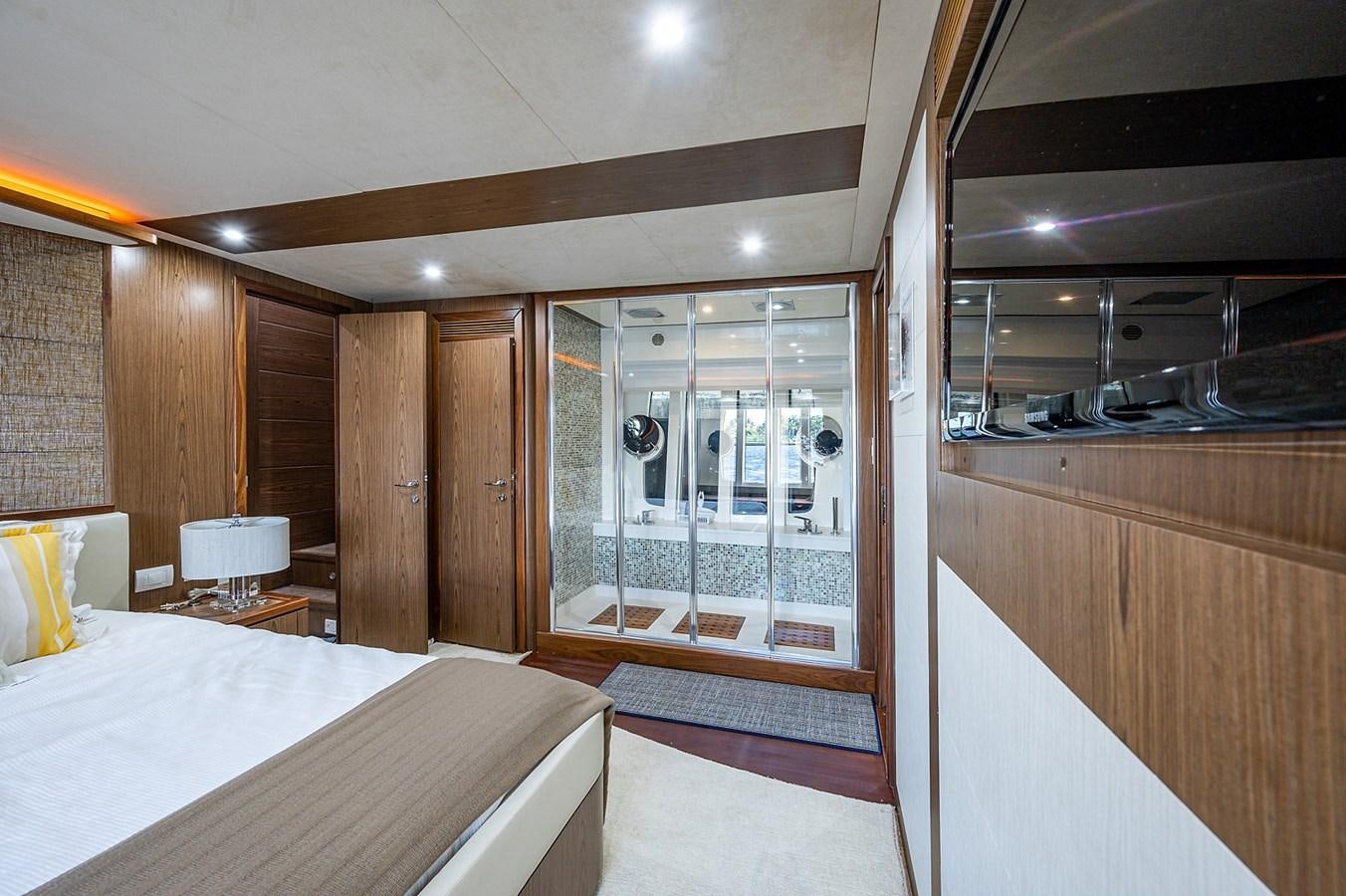 a bedroom with a bed and a window aboard FERRETTI Yacht for Sale