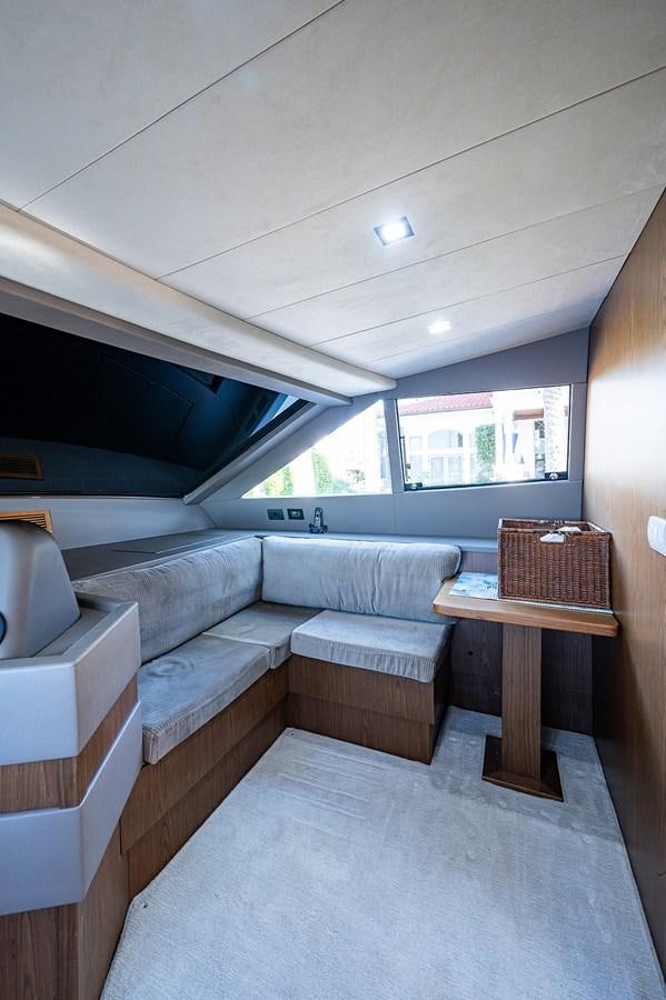 a room with a couch and a table aboard FERRETTI Yacht for Sale