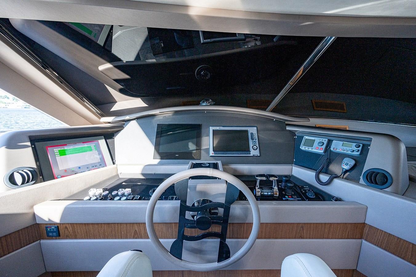 a car interior with a steering wheel and a computer monitor aboard FERRETTI Yacht for Sale