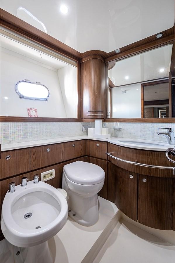 a bathroom with a toilet and a sink aboard FERRETTI Yacht for Sale