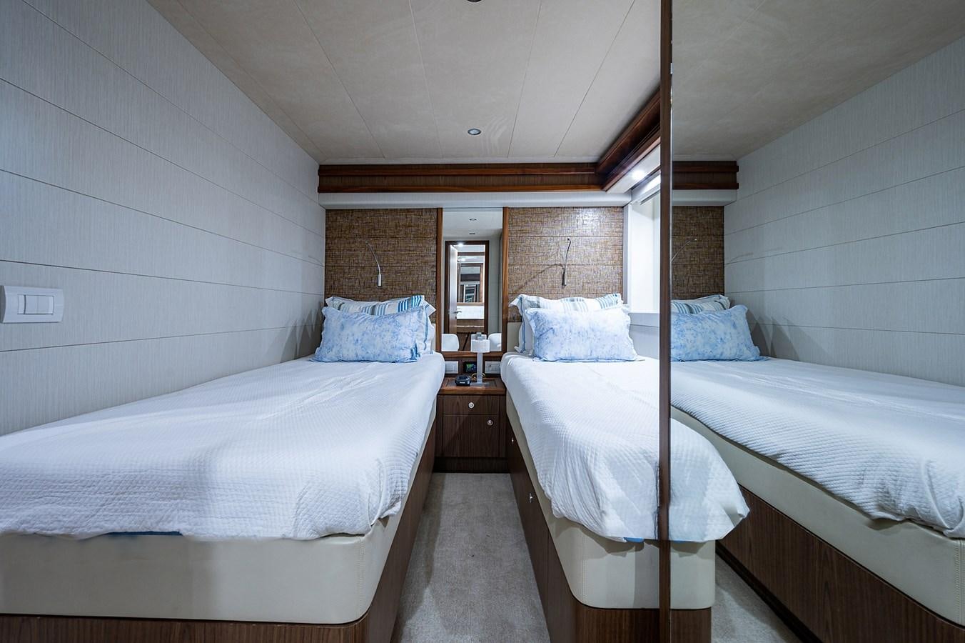 a couple of beds in a room aboard FERRETTI Yacht for Sale