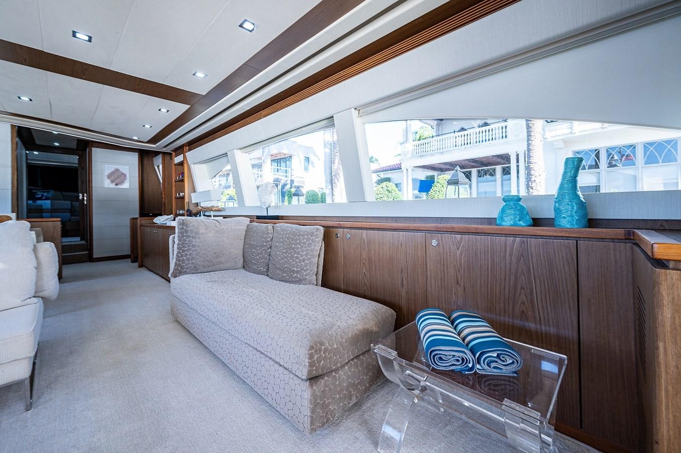 a living room with a couch and a table aboard FERRETTI Yacht for Sale