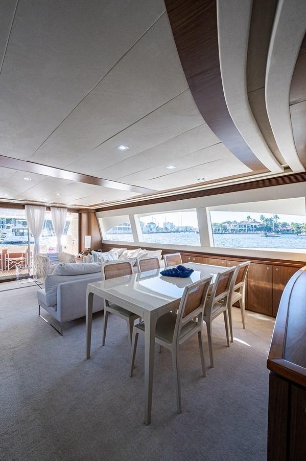 a room with a table and chairs aboard FERRETTI Yacht for Sale