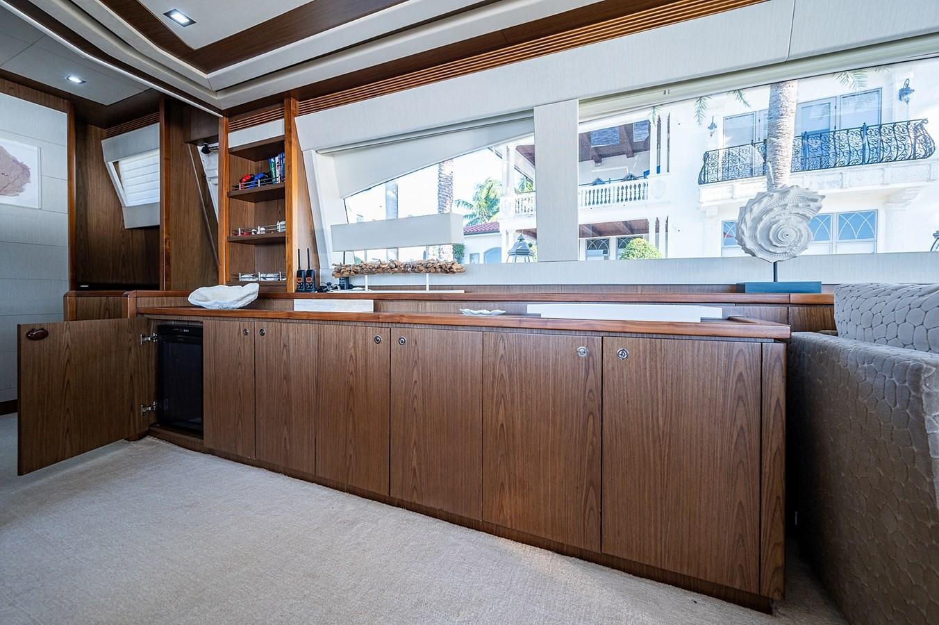 a room with a large window and a large table with chairs aboard FERRETTI Yacht for Sale