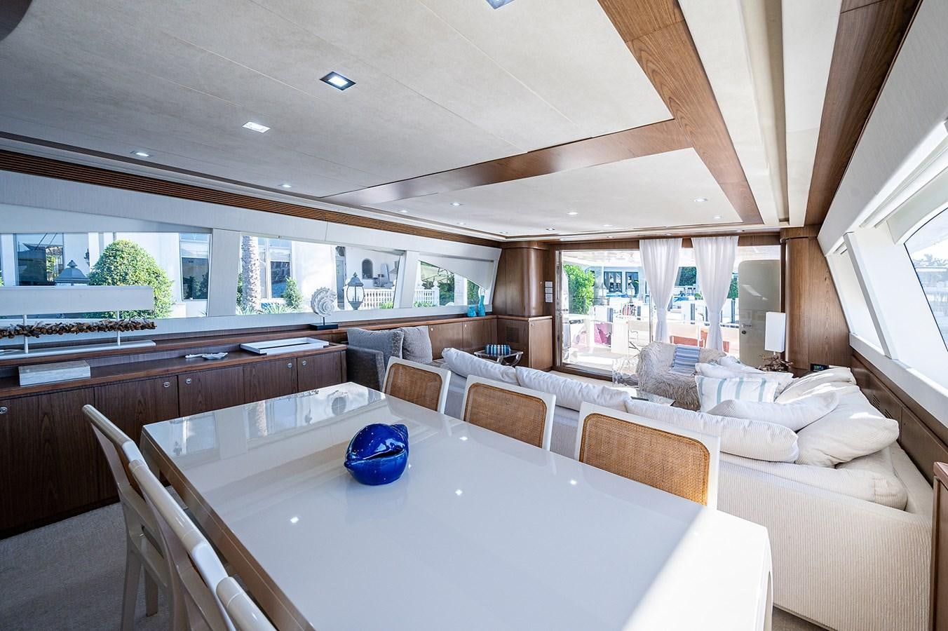 a large living room with a large table and chairs aboard FERRETTI Yacht for Sale