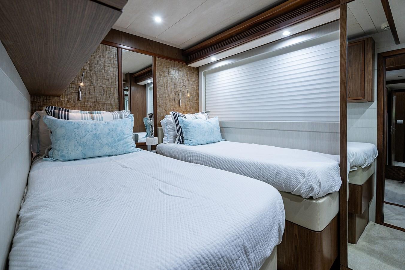 a couple of beds in a room aboard FERRETTI Yacht for Sale