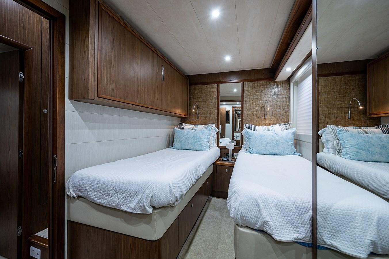 a couple of beds in a room aboard FERRETTI Yacht for Sale