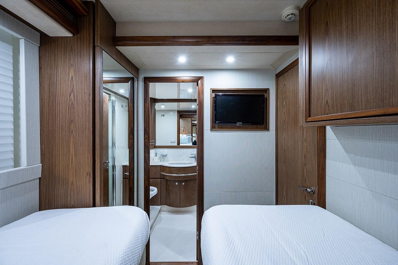 a bedroom with a bed and a television aboard FERRETTI Yacht for Sale