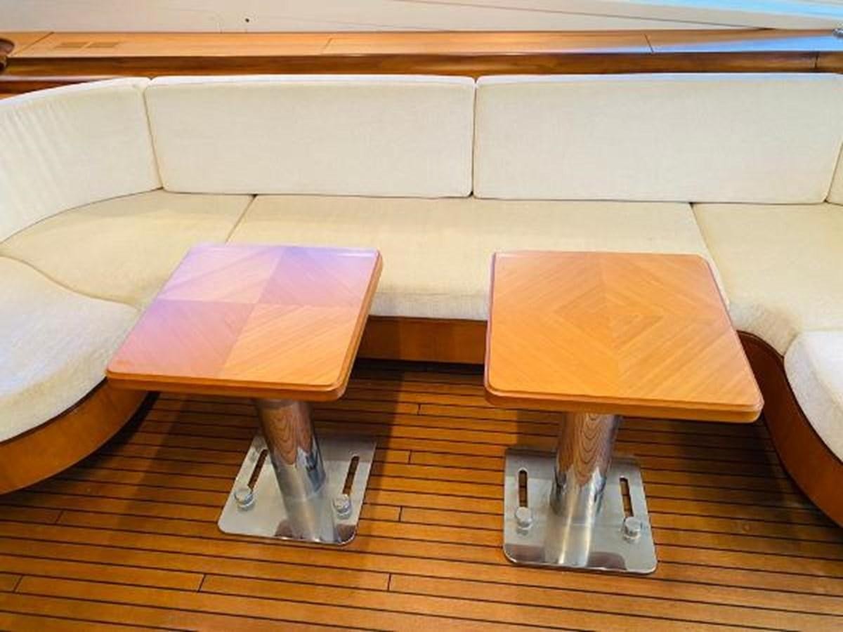 a coffee table and a glass on a coffee table aboard 2008 ARNO LEOPARD Yacht for Sale