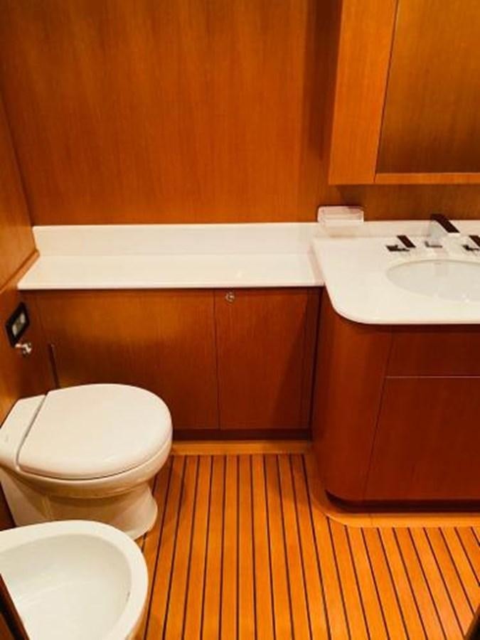 a bathroom with wooden cabinets aboard 2008 ARNO LEOPARD Yacht for Sale