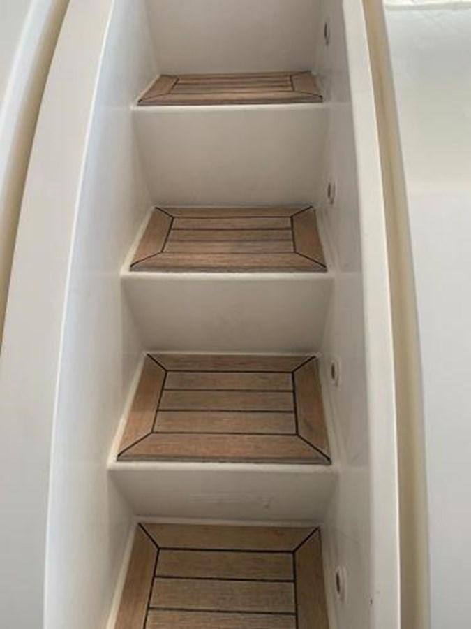 a white cabinet with wooden doors aboard 2008 ARNO LEOPARD Yacht for Sale