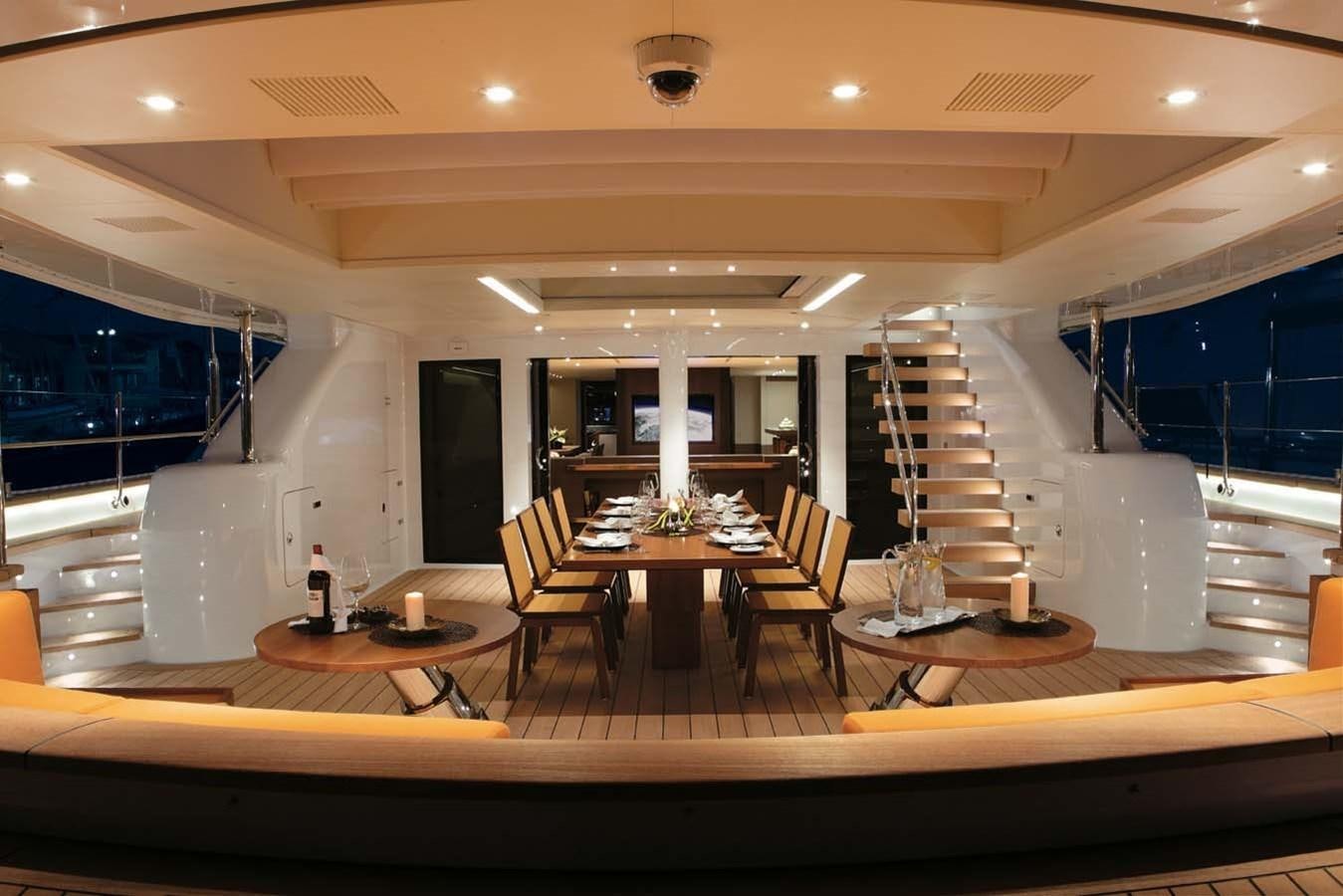 a large room with a staircase and tables aboard ENTERPRISE Yacht for Sale